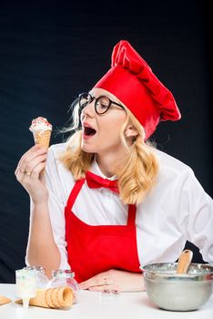 Vertical portrait of a cook with ice cream, shooting on a black background