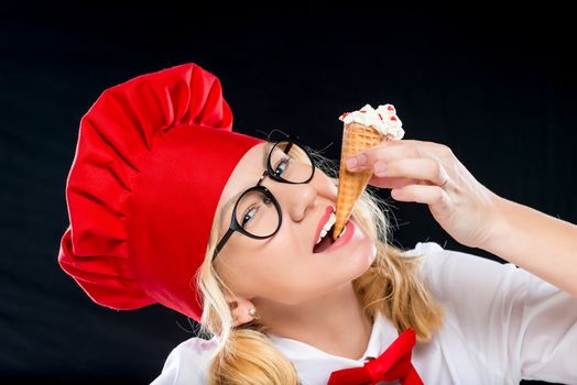 Close-up portrait of a beautiful chef with ice cream on a black background