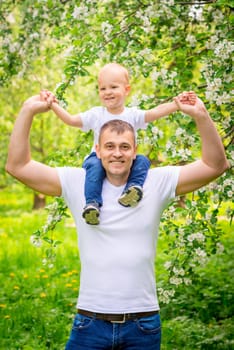Happy father with his young son in the park for a walk