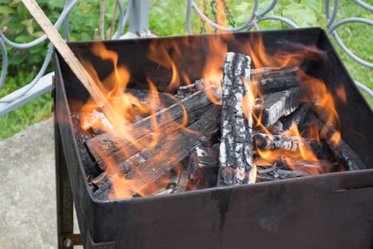 Closeup of logs burrning in preparation for nice barbecue