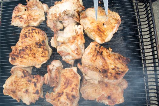 Closeup of grilled pork chops. Meat is still smoking on grill