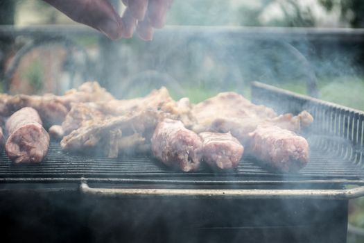 Grilling cevapi and pork chops.