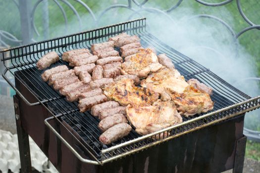 Grilling cevapi and pork chops.