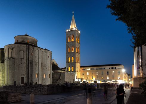 Green Square in Zadar, Croatia at sunset with the ancient church of St Donat and antique Roman square, long exposure, people unrecognizable and faces blurred