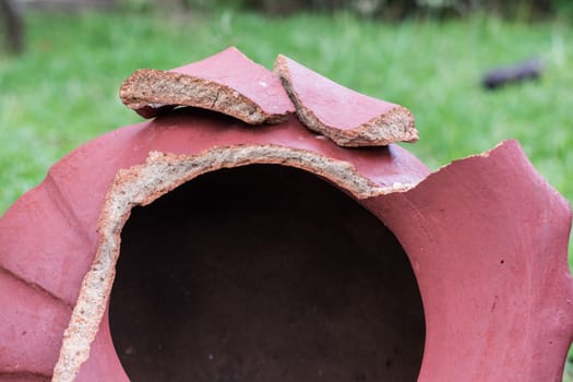 Close Up of Broken And Red Ceramic in a Garden.