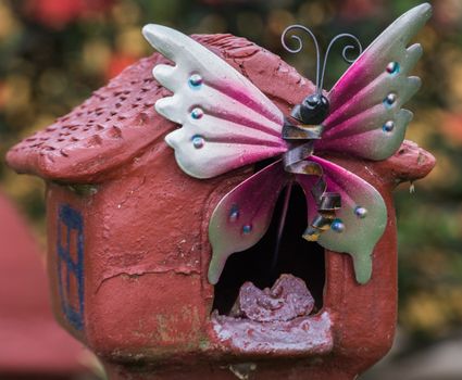Decorative Outdoor Metal Butterfly Fying Outside a Fake House