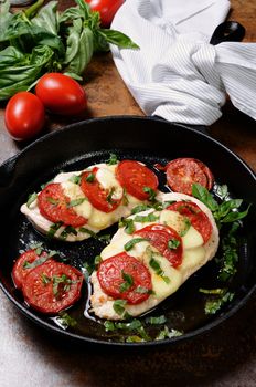 Langet from chicken breast with tomato and mozzarella. A-la caprese.