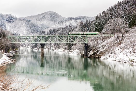 Train in Winter landscape snow on bridge