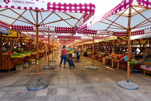 Zadar - July 3 2018: Local producers and merchants offering fresh local grown fruits and vegetables on the market. Due good climate conditions a variety of fresh products is available.