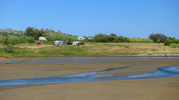 Open space camping ground on Famous Queens Beach in Nin near Zadar, Croatia. Rare sand beach in the Adriatic sea, due favorable wind the beach is popular for surfing and kitesurfing