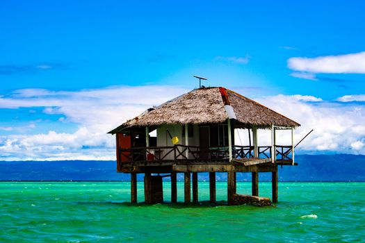 On the spit are houses on stilts. Water during the surf rises, cutting off the scythe from the land.