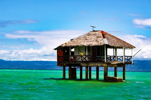 On the spit are houses on stilts. Water during the surf rises, cutting off the scythe from the land.