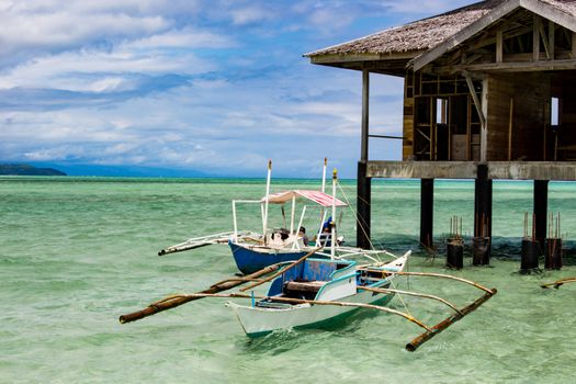 On the spit are houses on stilts. Water during the surf rises, cutting off the scythe from the land.