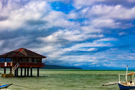 On the spit are houses on stilts. Water during the surf rises, cutting off the scythe from the land.