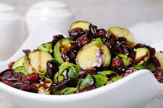 Salad from Brussels sprouts with dried cranberries under balsamic sauce