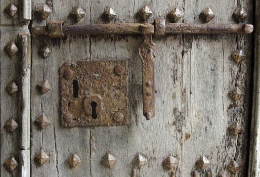 old lock on a studded wooden door