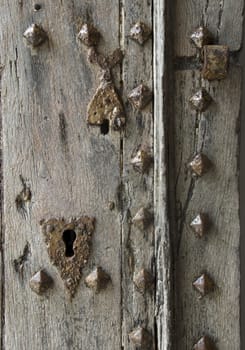 old rusty iron lock on a wooden door