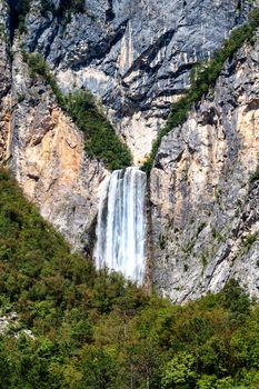 Famous slovenian waterfall Boka Alps in Triglav National park, Slovenia is one of the highest and most magnificient waterfalls in european Alps with 106m in height, vertical close up zoom, rare view