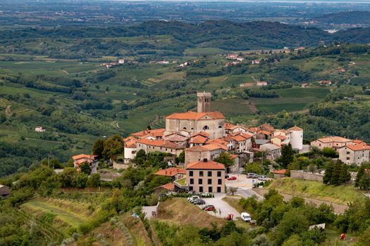 Panoramic view of Smartno in Gorska Brda, Slovenia from above with surrounding vineyards, olive plantations and orchards.