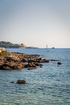Sea and rocky coast in Majorca with sailboats