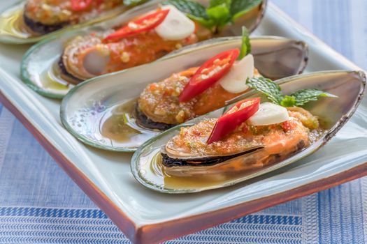 seafood dish with green mussel and  spicy sauce