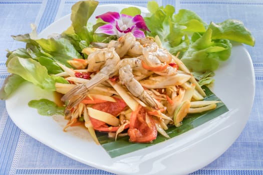 Traditional thai cuisine spicy green papaya salad with shrimp