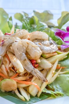 Traditional thai cuisine spicy green papaya salad with shrimp