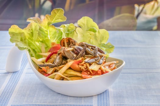 Traditional thai cuisine spicy green papaya salad with crab