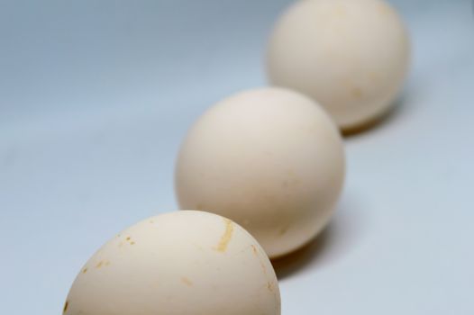 Three eggs isolated over a white background.