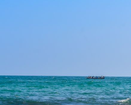 Photograph of Rowing Boat in Sea taken from a distance during Christmas Holiday or New Year celebration time in landscape style Use for background website banner usage Travel vacation holiday concept
