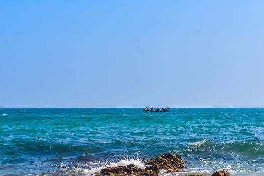 Photograph of Rowing Boat in Sea taken from a distance during Christmas Holiday or New Year celebration time in landscape style Use for background website banner usage Travel vacation holiday concept