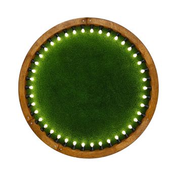Close up one round shape wooden ring light frame with lightbulbs and backdrop of illuminated vivid green plastic artificial grass, isolated on white background