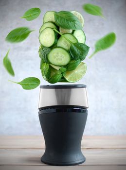 Fresh green fruits and vegetable smoothie ingredients spinning around a blender 