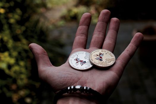 Europe leaving. Silver and gold brexit coins with british map. England.