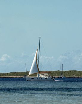 Small White Yachts in Beauty Harbor against Azure Sky near North West Coast of Menorca, Balearic Islands 