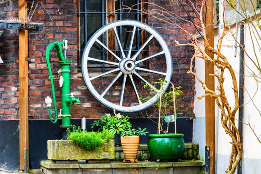 Backyard decoration, old wooden cart wheel, water pump various decoration material.
