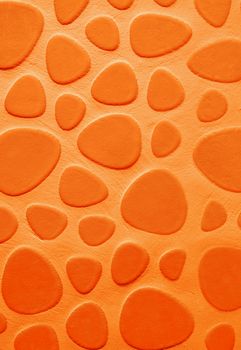 Background of Orange Droplet Shaped Stone on Cement Wall closeup