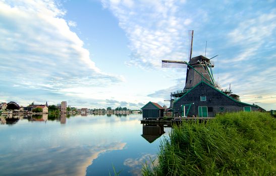 Zaanse Schans Windmill De Kat from River Coast with Reflection of Sky Early Morning Outdoors
