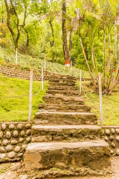 Photograph of Natural stone landscaping in home garden with stairs snapped in landscape wide screen style in daytime on a sunny day. Architecture exterior and interior designing concept.