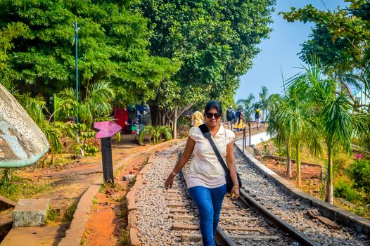 Blonde girl balancing on railway track. The photograph suitable on the cover, poster, wallpaper, website