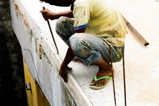 industrial worker, bricklayer, mason working on construction site with bricks and building house. masonry details