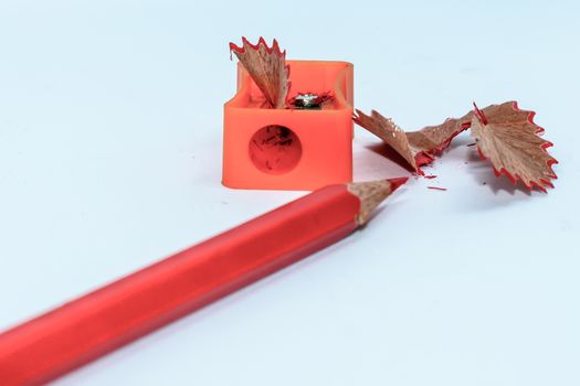 Selective Focus: Color pencil with sharpener shavings on white background