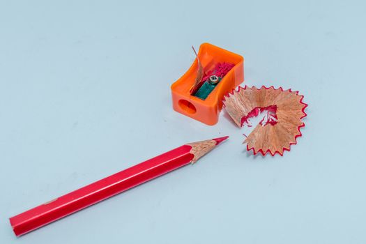 Selective Focus: Color pencil with sharpener shavings on white background