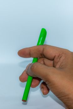 Close up of hand carrying a pen. Popular gesture of communication in business or day to day life.