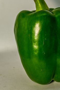 fresh green bell pepper (capsicum) on a white background.