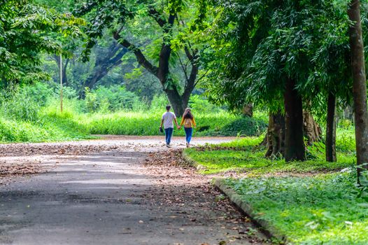 Happy married Cute couple walking in the park. Love relationship and dating concept.