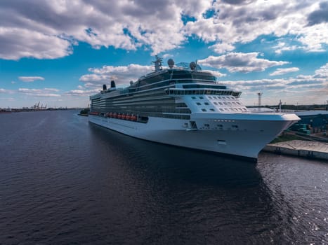 Big white passenger ship moored at the cargo port
