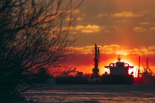Colorful winter sunrise against the cargo port