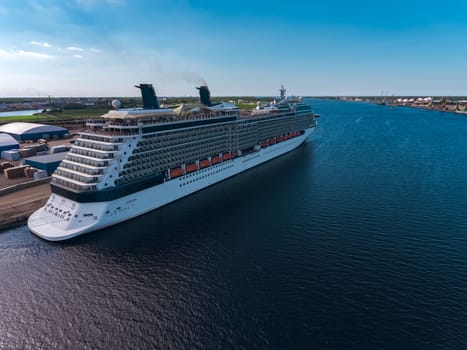Big white passenger ship moored at the cargo port