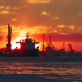 Colorful winter sunrise against the cargo port